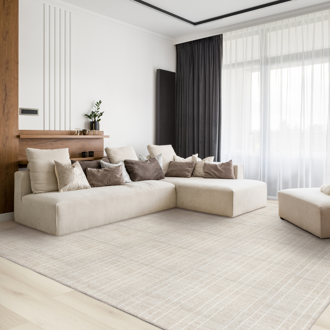 Light hardwood flooring with a cream area rug in a living room
